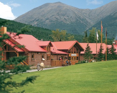 Exterior of the Kenai Princess Lodge with mountains in the background