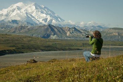 Woman taking photograph of Denali