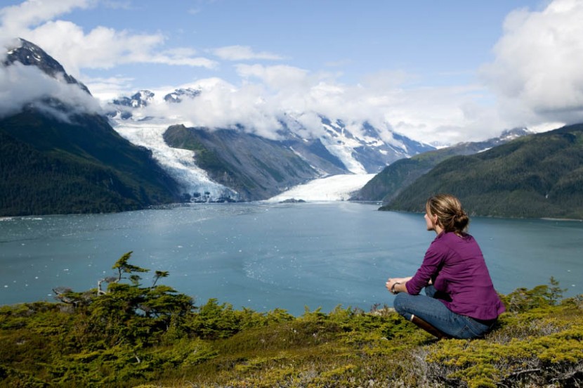 one woman sitting and thinking in prince william sound alaska overlooking columbia glacier